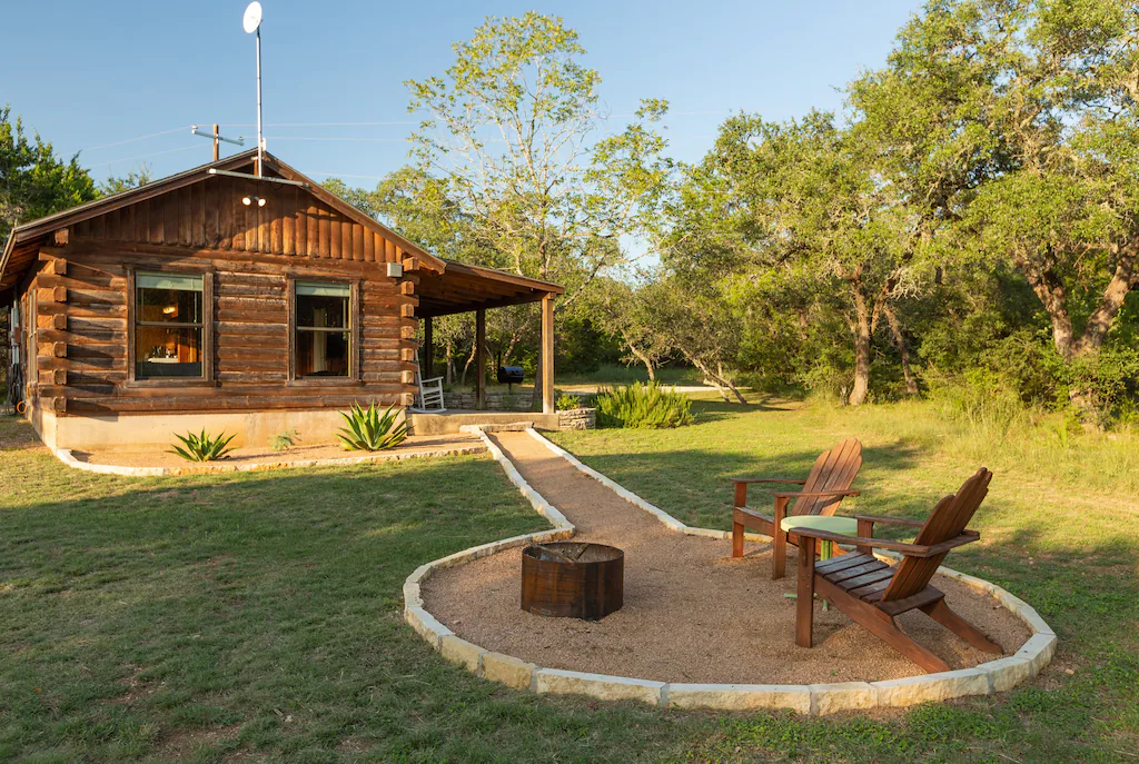 Outside are wooden chairs around the fire pit.
