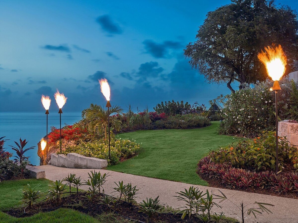 Vast and meticulously maintained grounds surrounding the villa, featuring manicured lawns, vibrant gardens, meandering pathways, and scenic spots for relaxation and recreation.