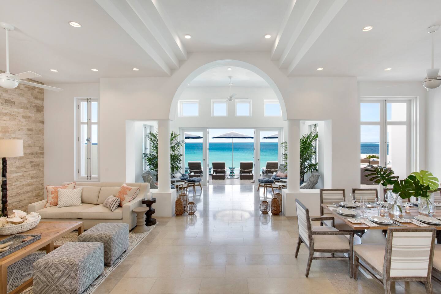 Inside the villa, the living area and dining area are elegantly furnished, offering a seamless blend of indoor comfort and breathtaking beach views.