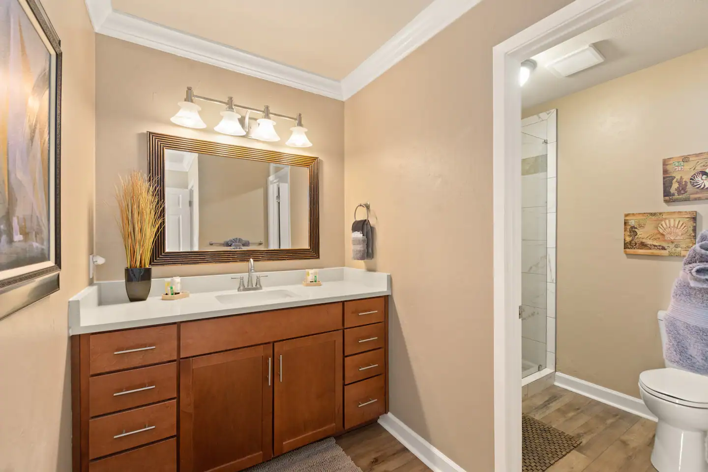 A walk-in shower with seamless glass and an in-shower bench in the private bathroom.